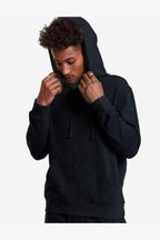 Man adjusting the hood of a dark charcoal heather SpectraUSA Heavyweight Pullover Hood fleece.